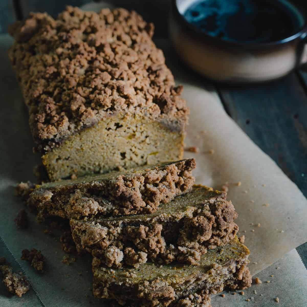 Sliced pumpkin bread on a rustic table.