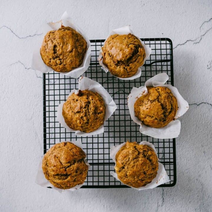 six muffins on a wire rack.