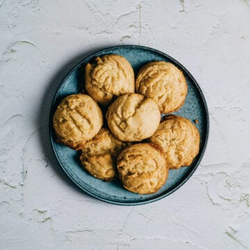 a green plate filled with freshly baked cookies.