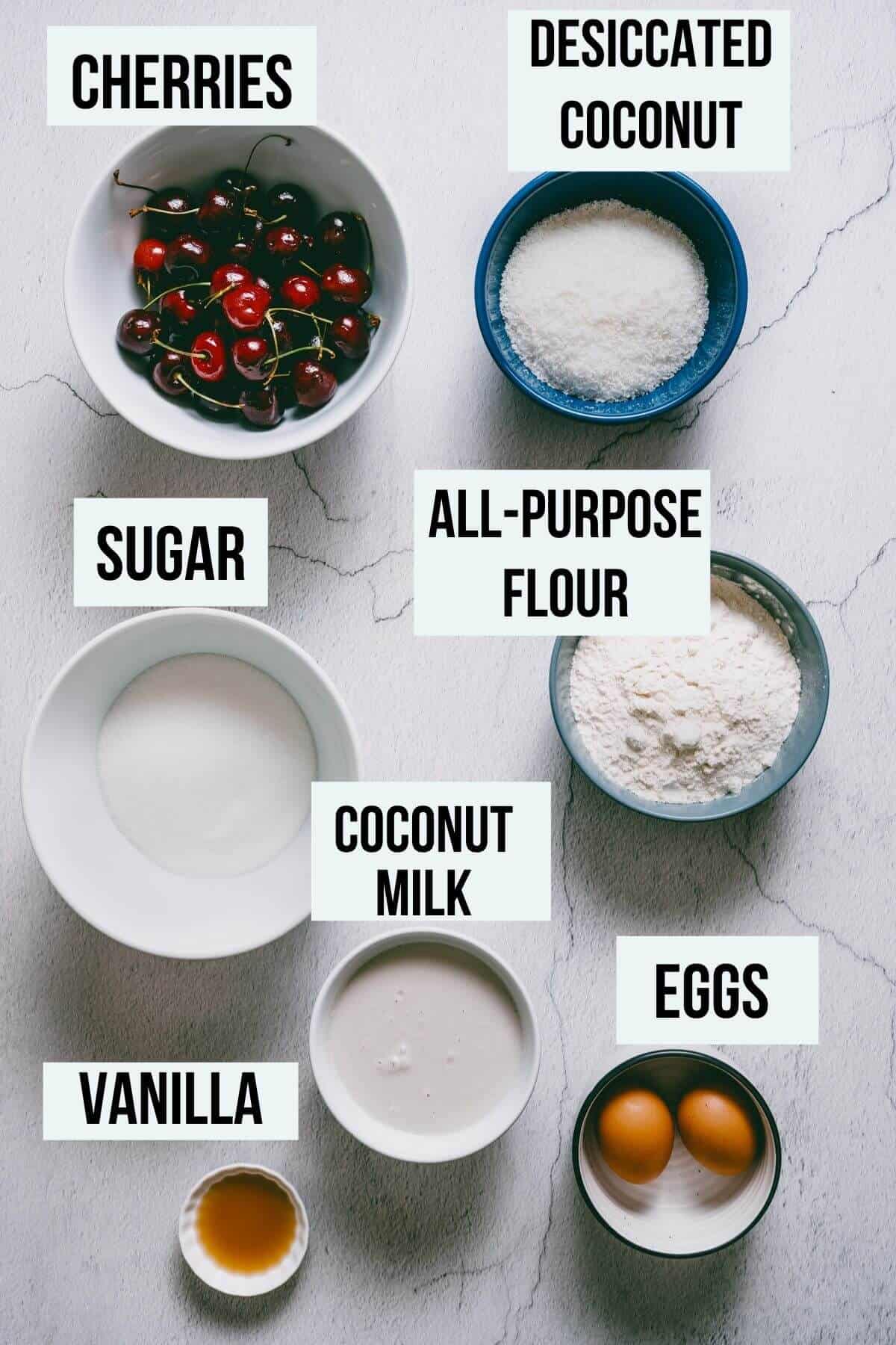 ingredients on a concrete table to make cherry and coconut cake.