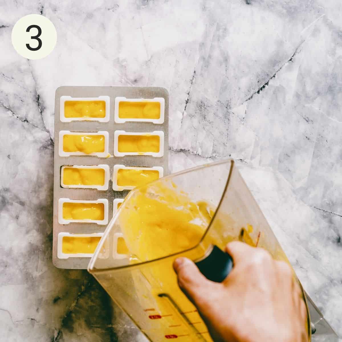 pouring pureed mango into popsicle molds.