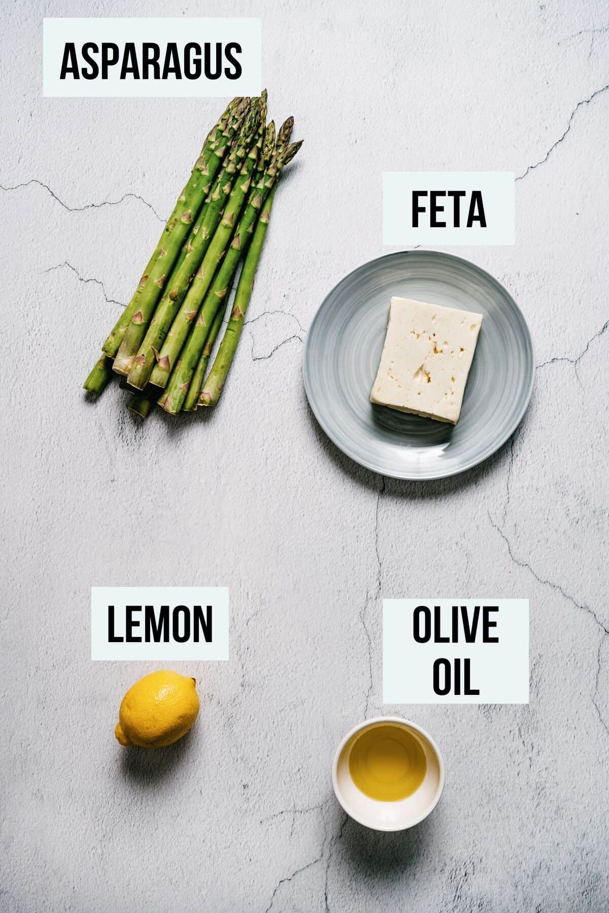 ingredients on a white table to make asparagus with feta.