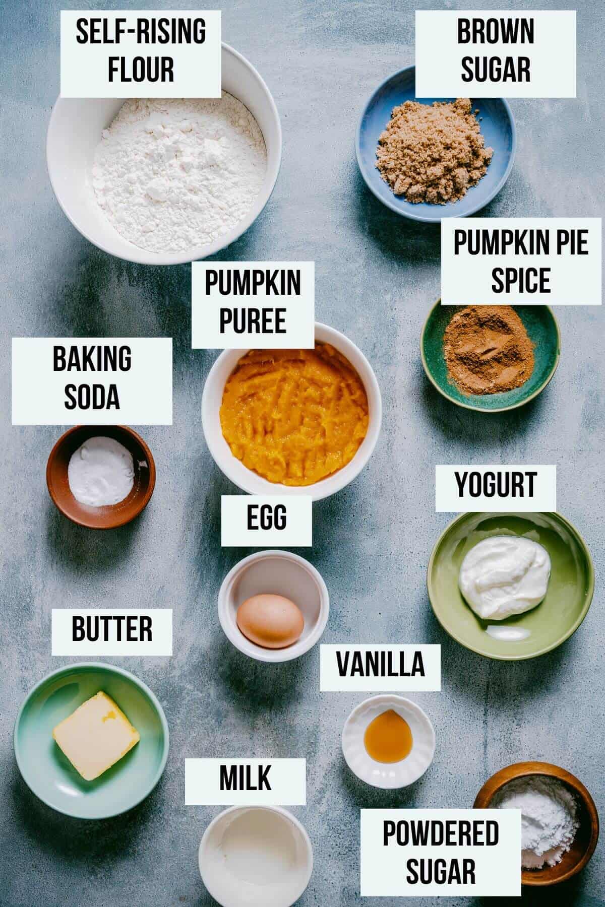 ingredients for healthy pumpkin scones on a grey table.