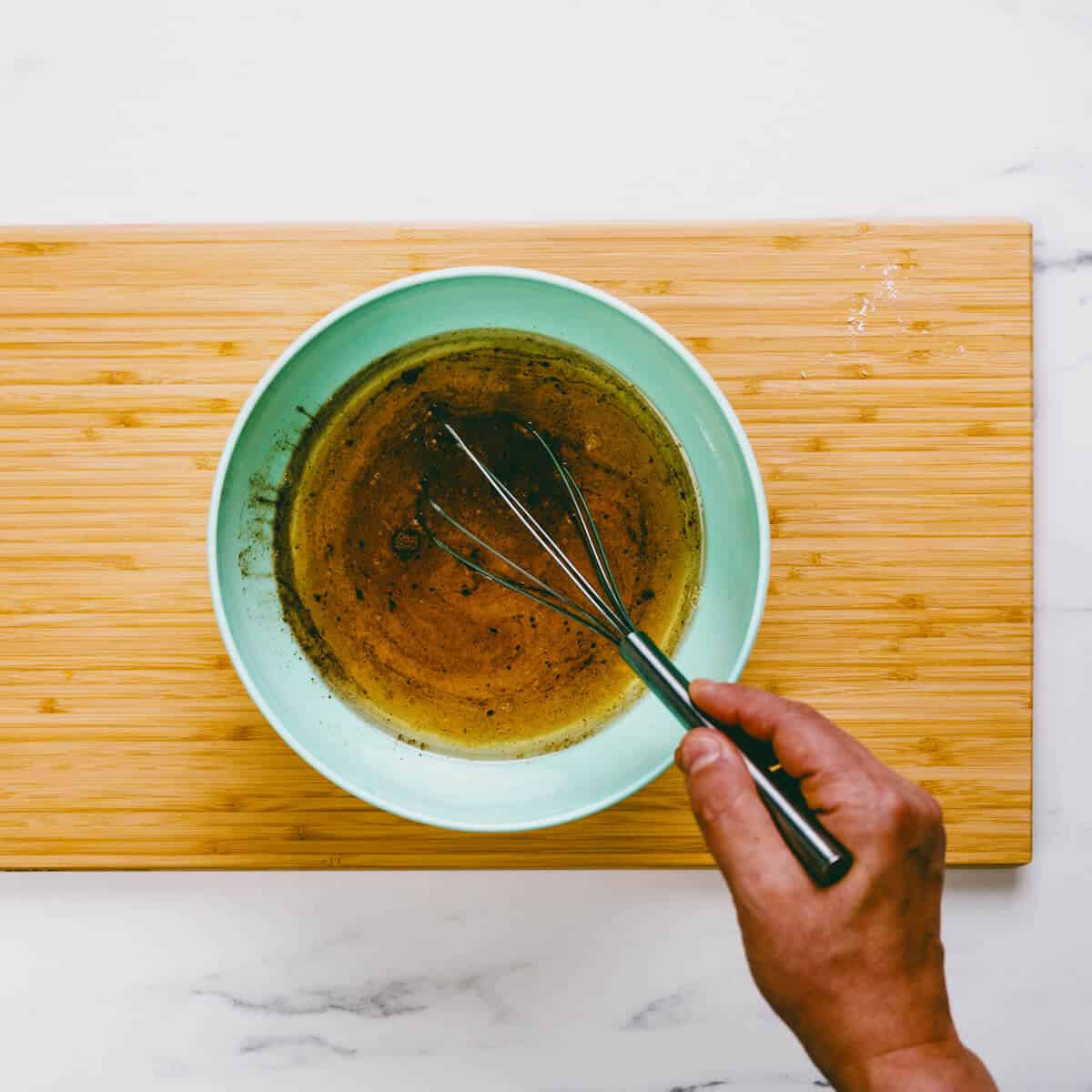 whisking the wet ingredients to make olive oil cookies.