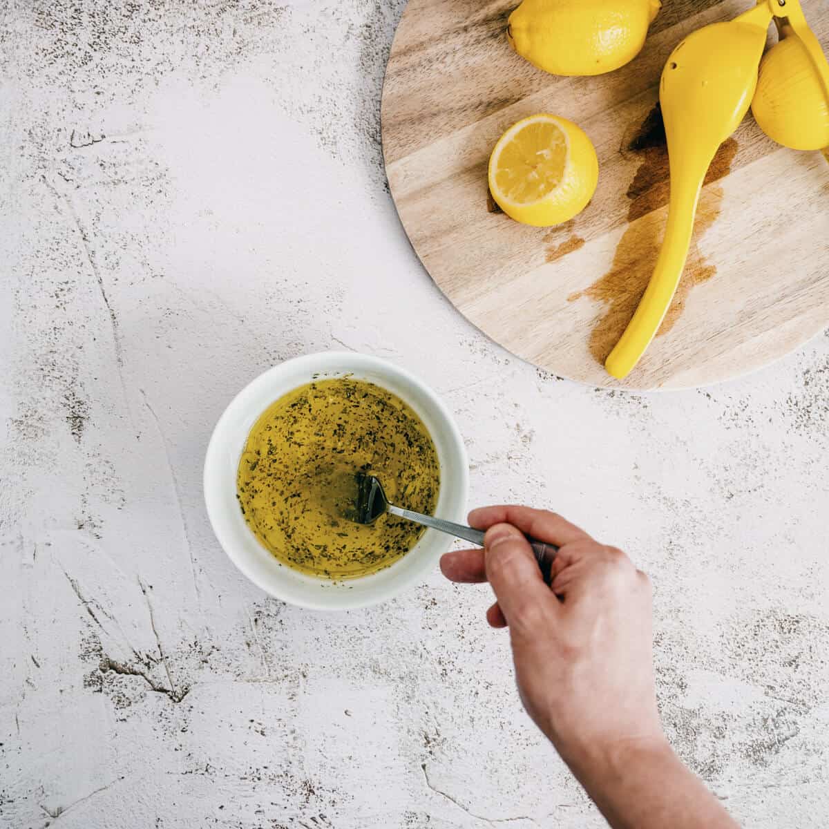 whisking ladolemono - a Greek olive oil sauce.