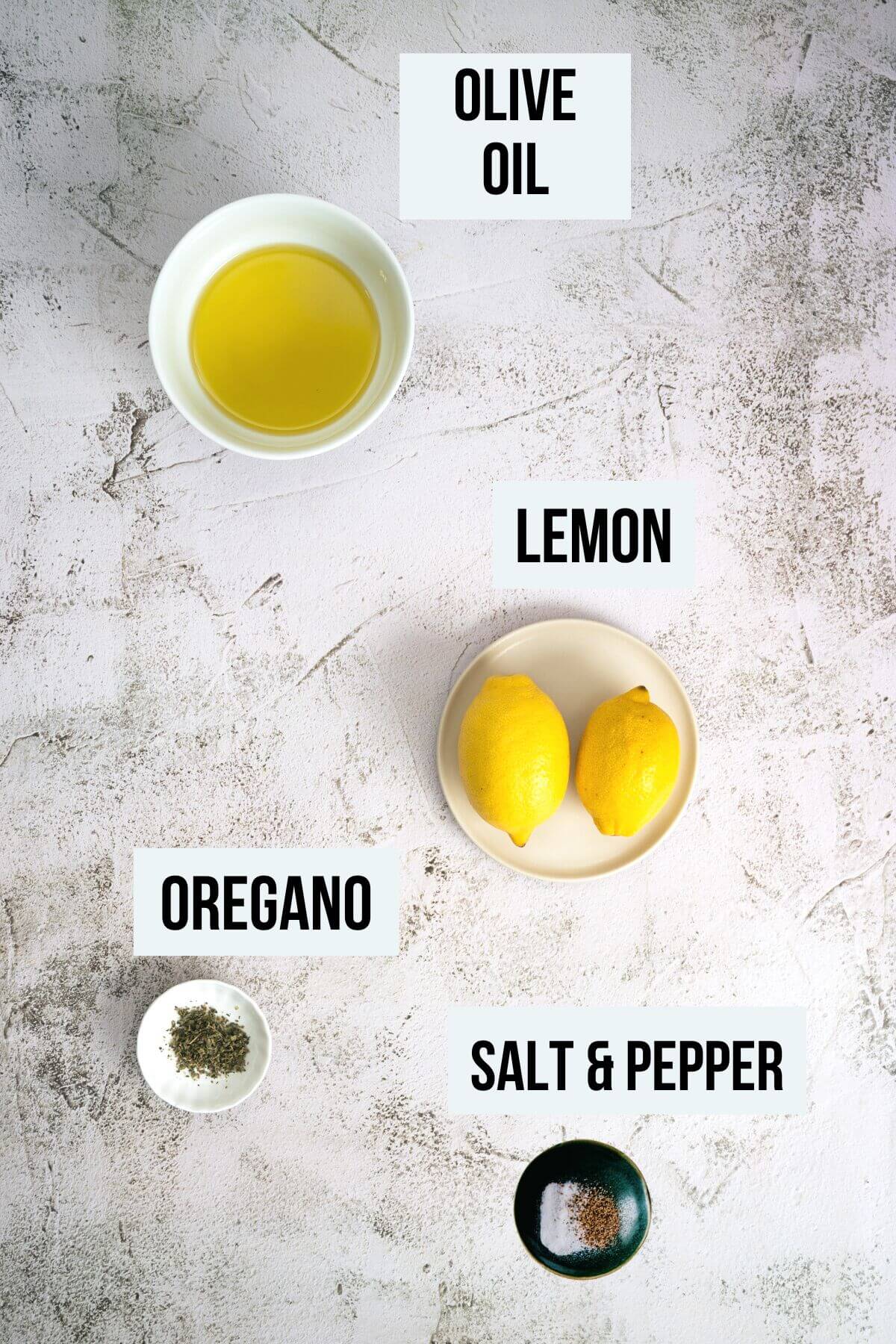 ingredients required to make ladolemono on a white table.