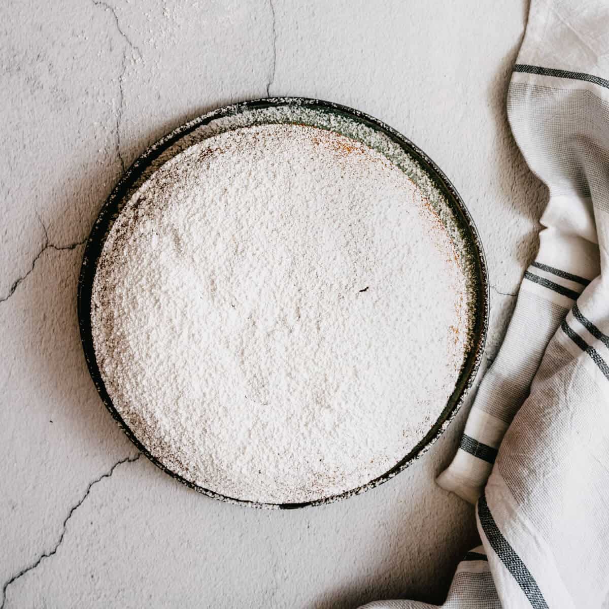 Greek vasilopita cake on a stone table.