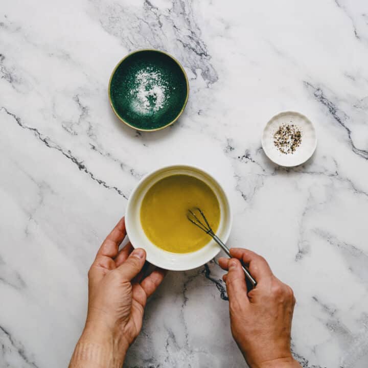 whisking olive oil in a small bowl.