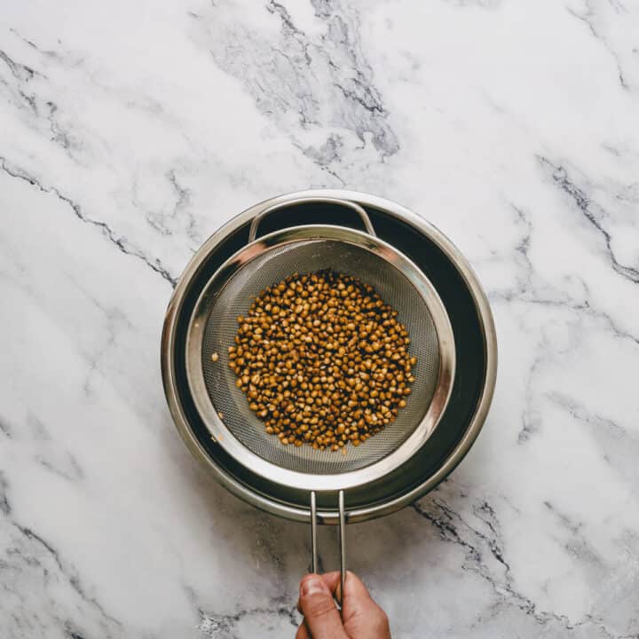 draining and rinsing canned lentils in a sieve.