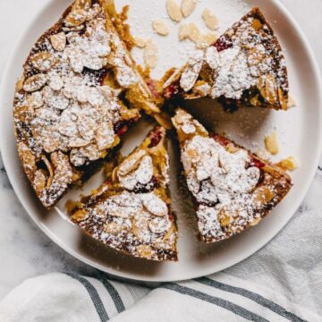 a white plate with slices of raspberry almond cake.
