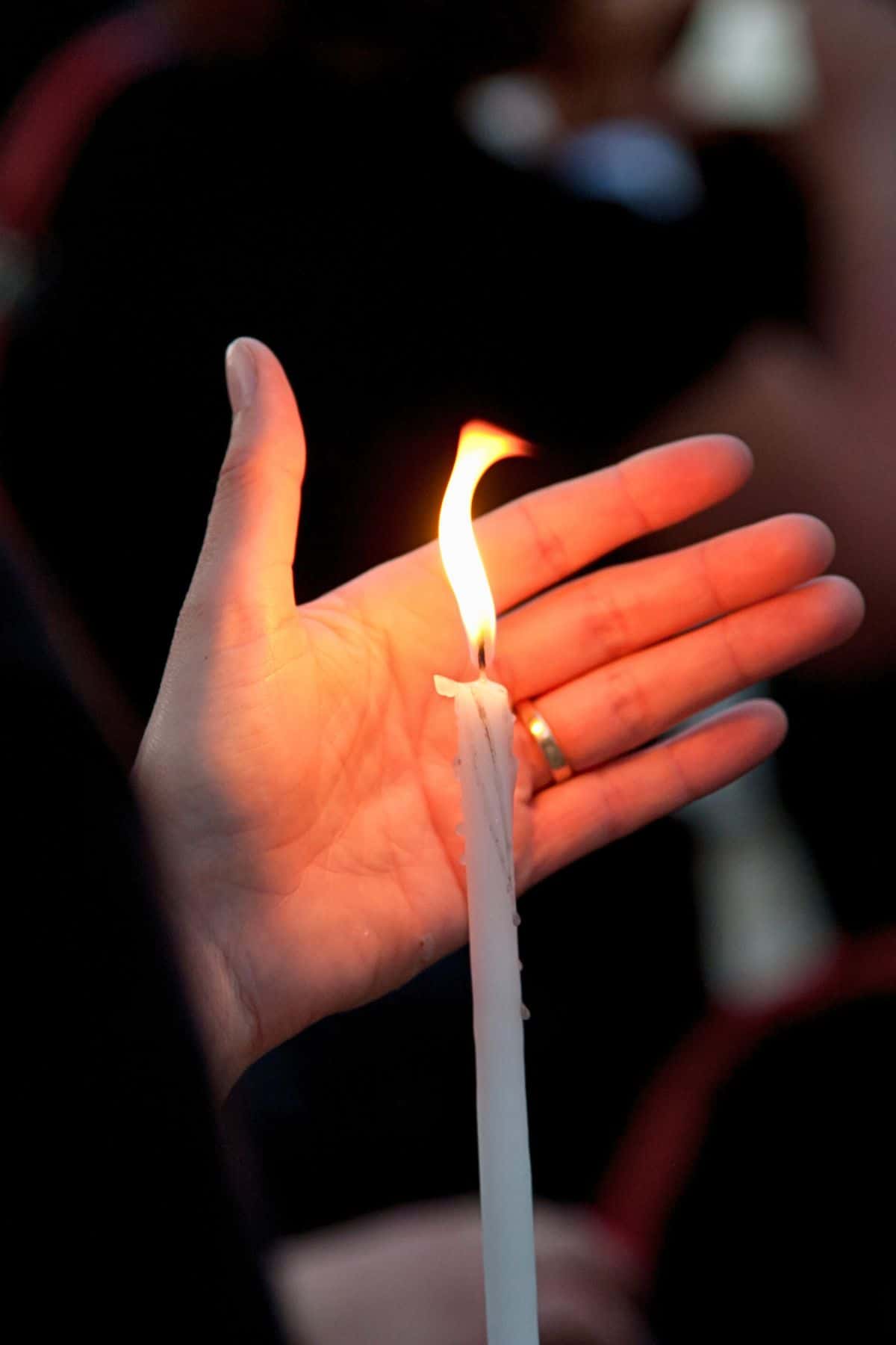 a hand protecting the Holy Light after Greek Easter church service.