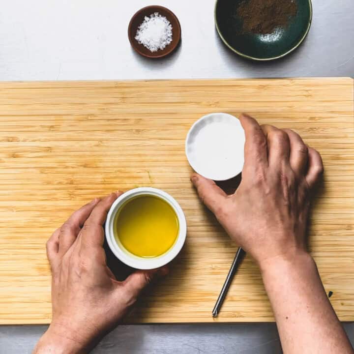 olive oil and vinegar about to be mixed for a dressing.
