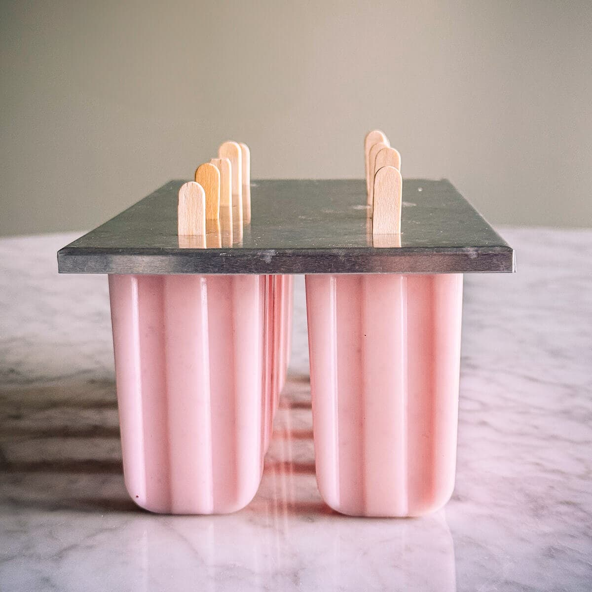 popsicle molds holding popsicles.