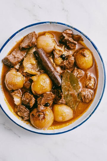 finished dish of beef stifado served in a white dish.