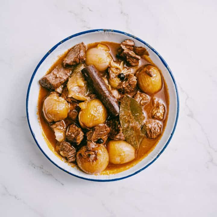 finished dish of beef stifado served in a white dish.
