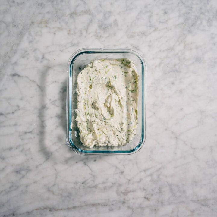 Tzatziki stored in a glass container.