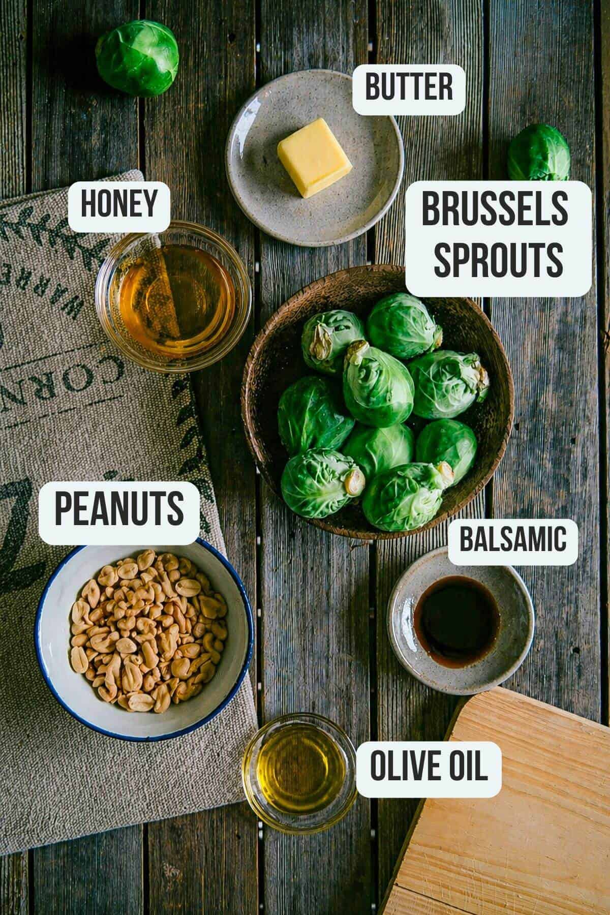 Ingredients for roasted Brussels sprouts with honey and peanuts, including butter, balsamic and olive oil.