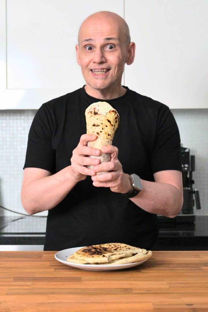 PeterG (owner of Souvlaki For The Soul) holding a handmade wrapped greek pita bread.