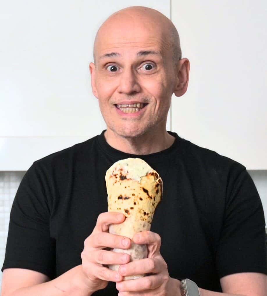 PeterG (owner of Souvlaki For The Soul) holding a handmade wrapped greek pita bread.