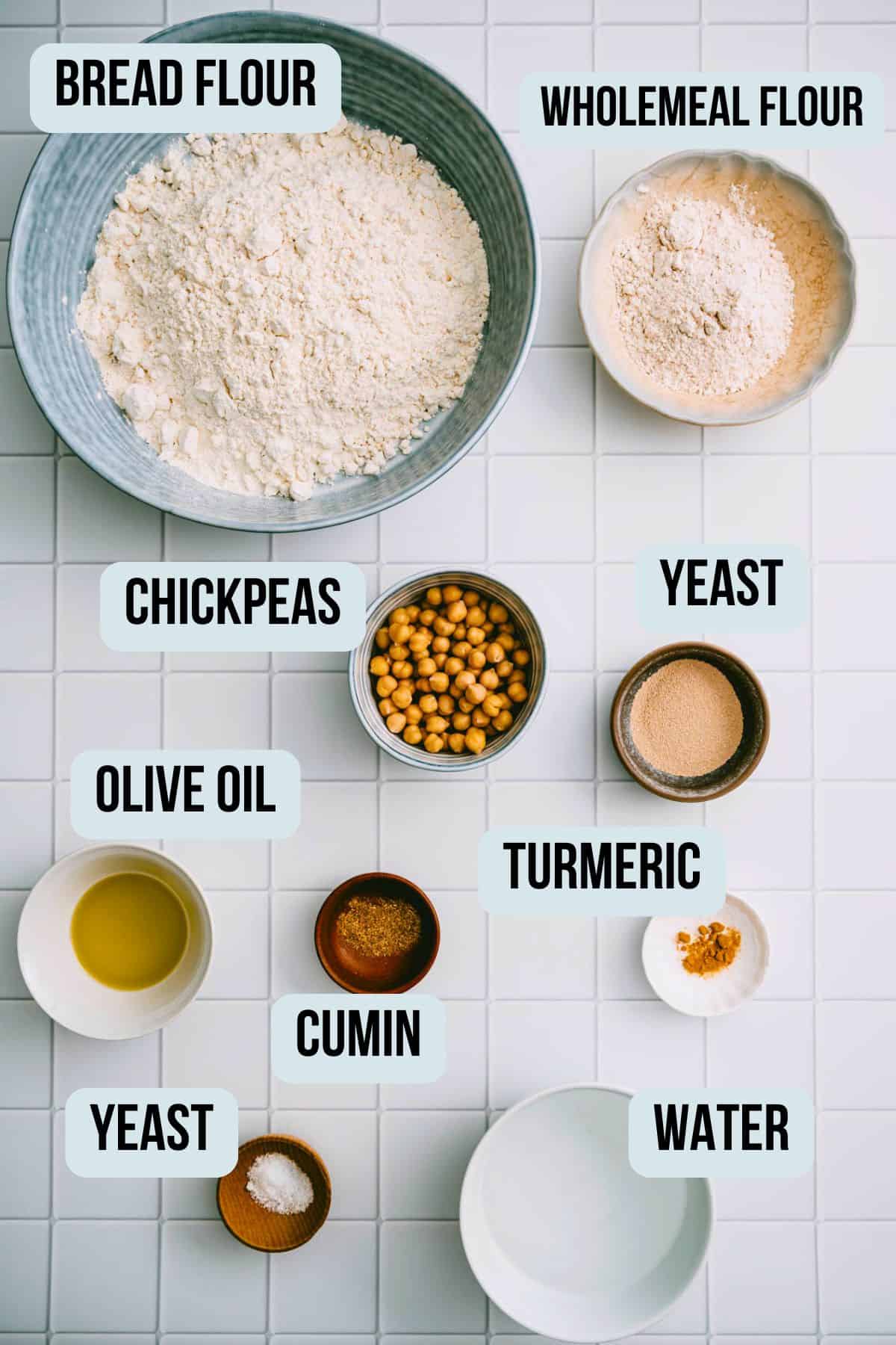 Ingredients needed to make chickpea flatbread on a tiled surface.