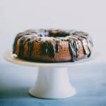 Chocolate beetroot cake on a cake stand with glossy dark chocolate ganache.