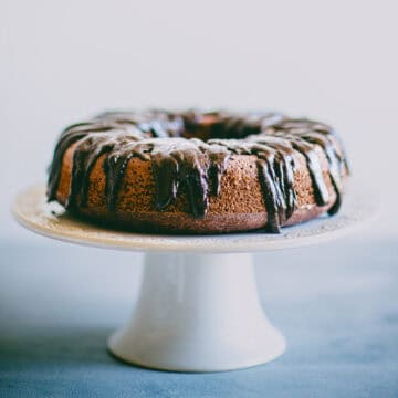 Chocolate beetroot cake on a cake stand with glossy dark chocolate ganache.