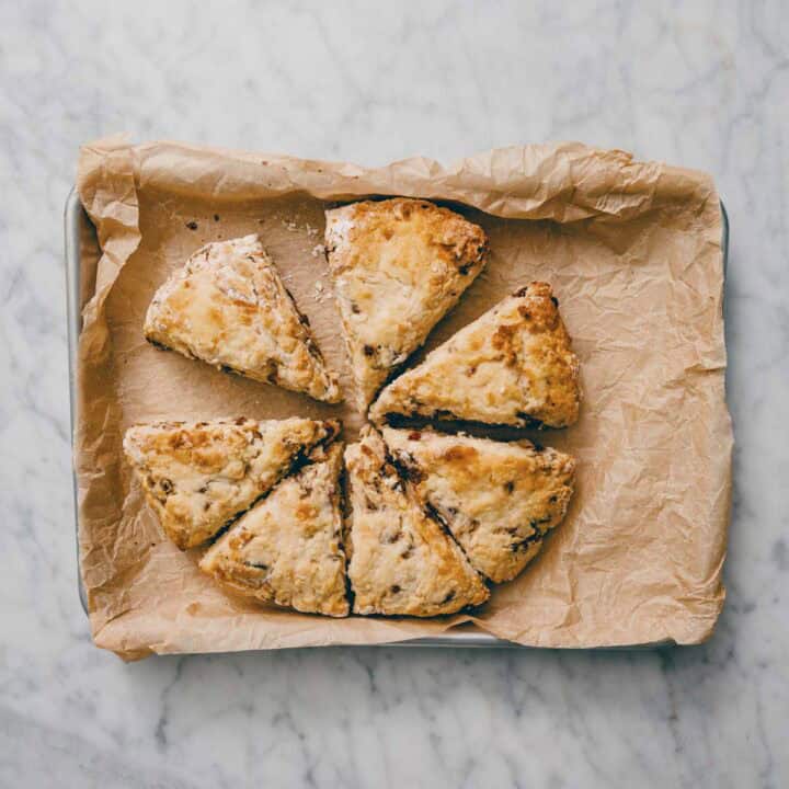 baked date scones on tray lined with parchment paper.