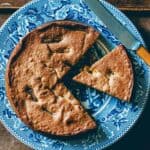 Dried fig and almond cake sliced on serving plate.